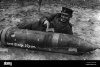 a-german-soldier-amuses-himself-over-an-unexploded-russian-bomb-M4HFT8.jpg