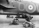 1940_an-aircrew-officer-of-no-30-squadron-raf-checks-the-bomb-load-on-a-light-series-carrier-f...jpg