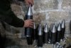 A Free Syrian Army fighter assembles homemade missiles at a workshop in north Aleppo.jpg