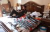 A member of the Free Syrian Army lies down on a bed next to weapons inside a house in Aleppo.jpg