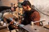 A man works on an improvised mortar shell for the Free Syrian Army inside a factory which previo.jpg