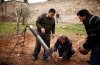 Free Syrian Army fighters prepare a homemade missile before they launch it towards the military .jpg
