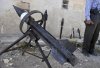 Rebel arms maker Abu al-Fadhel shows off a row of homemade weapons including a hand-grenade.jpg