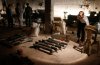 Syrian rebel fighters stand around a cache of homemade missiles in Aleppo.jpg